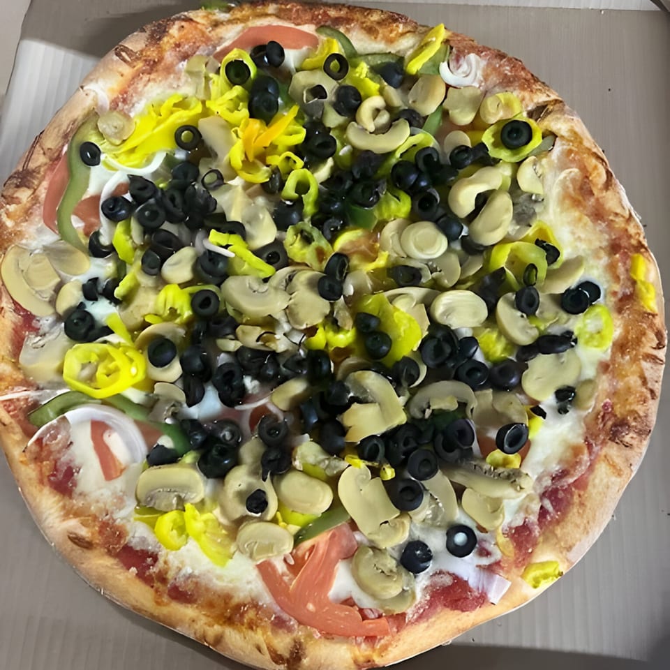 Al's Pizza veggie pizza with black olives, banana peppers, mushrooms, green peppers, and tomatoes.